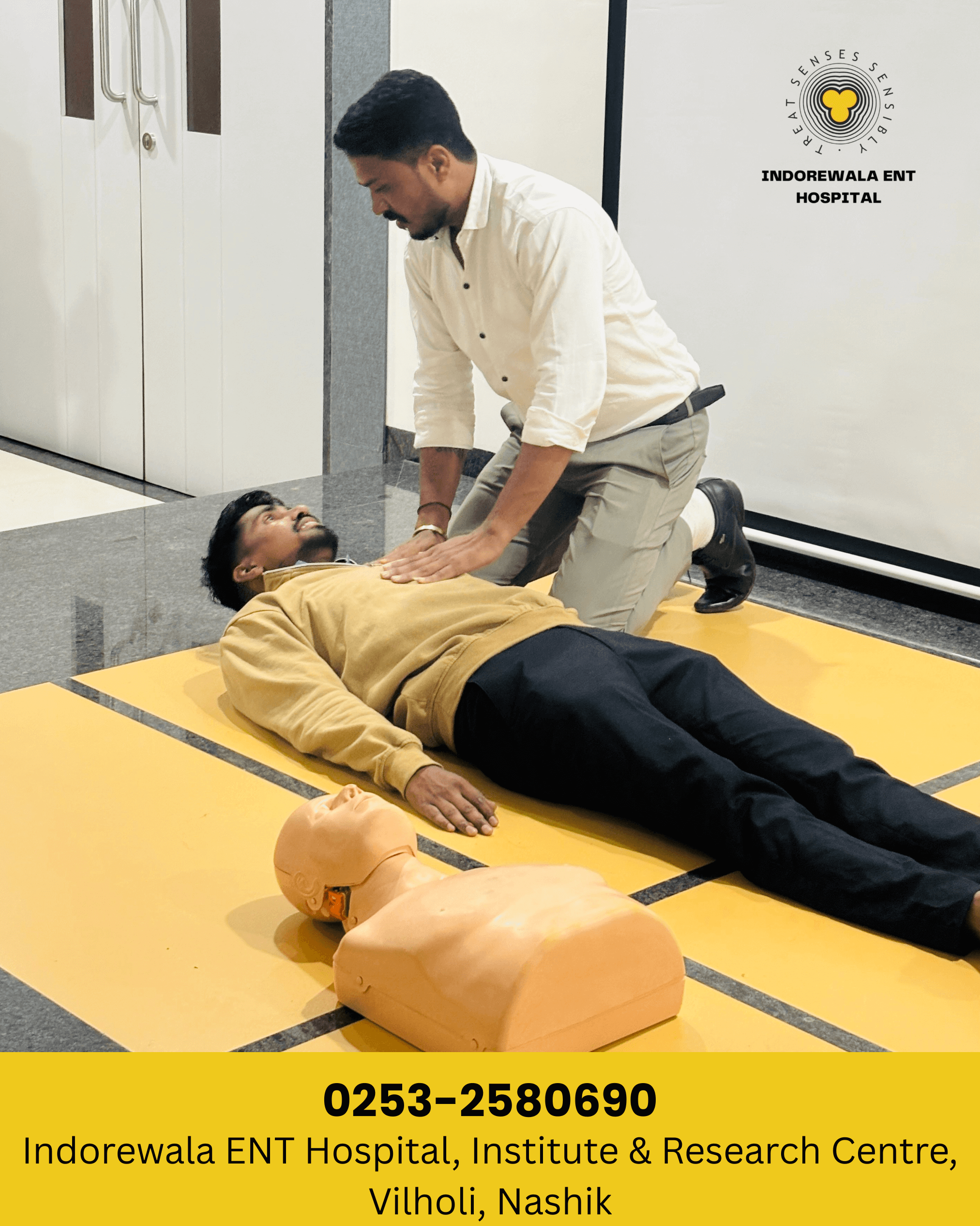 Dr. Nilesh Tatar explaining CPR steps  for compressions to hospital staff Indorewala ENT Hospital